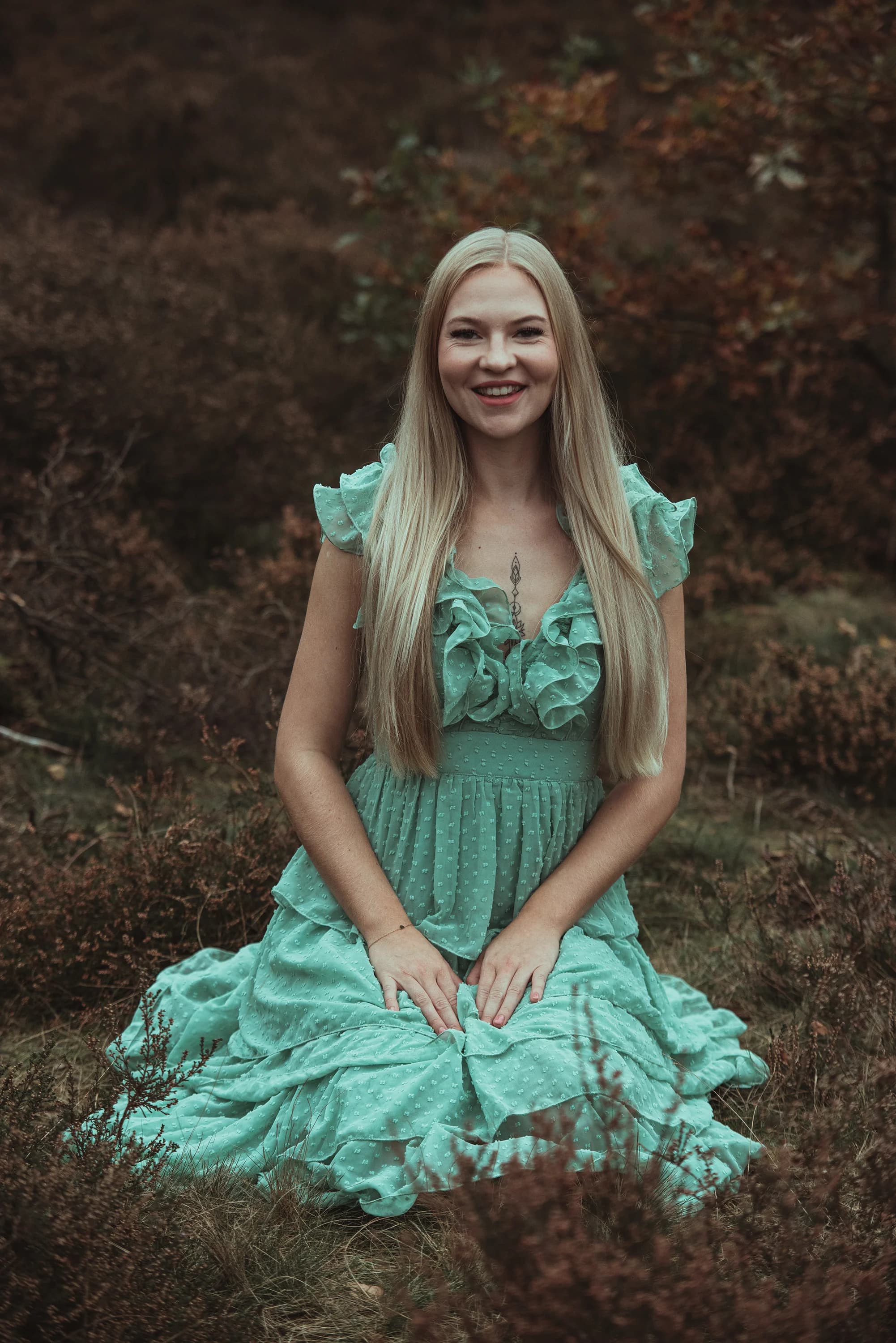 Portretfotografie van een vrouw in groene jurk op de heide bij Veenendaal